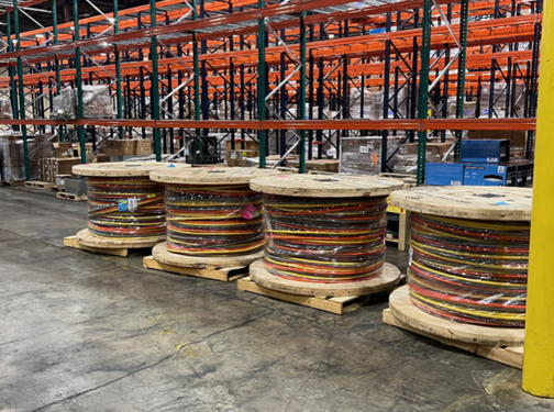 electrical surplus buyer in West Palm Beach FL reviewing labeled cable reels