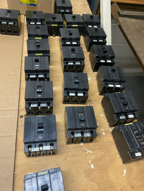 electrical surplus buyer in West Palm Beach FL reviewing sorted molded-case breakers